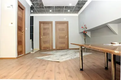 a room with a table and wooden doors at biglife hotel in Istanbul
