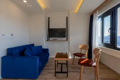 a living room with a blue couch and a table at Union Hotel Karaköy in Istanbul
