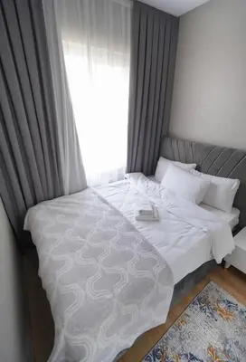 a bedroom with a large white bed with a window at King Suite TH28 in Esenyurt