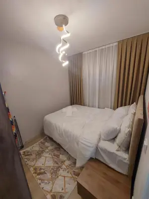 a bedroom with a white bed and a light at Classic Suite TS33 in Esenyurt