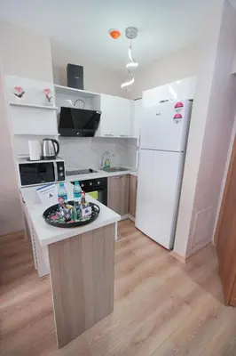 a kitchen with a white refrigerator and a counter top at Classic Suite TS33 in Esenyurt