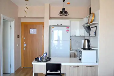a kitchen with a counter and a white refrigerator at Classic Suite TS22 in Esenyurt