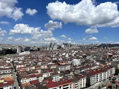 a view of a city with buildings and clouds at King Suite OJ9 in Esenyurt
