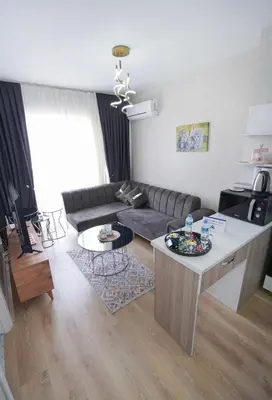 a living room with a couch and a table at Classic Suite TS23 in Esenyurt