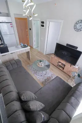 a living room with a couch and a table at Classic Suite TS23 in Esenyurt