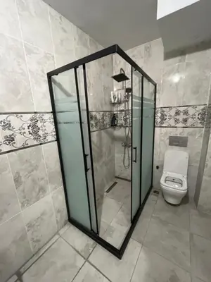 a bathroom with a shower and a toilet at Airport See Viem Apartment in Arnavutköy