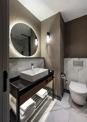 a bathroom with a sink and a toilet and a mirror at Livro Hotel in Istanbul