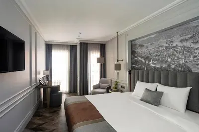 a bedroom with a bed and a large painting on the wall at Livro Hotel in Istanbul