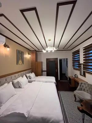 a large bedroom with two beds and a chandelier at PALMERA ART HOUSE in Istanbul