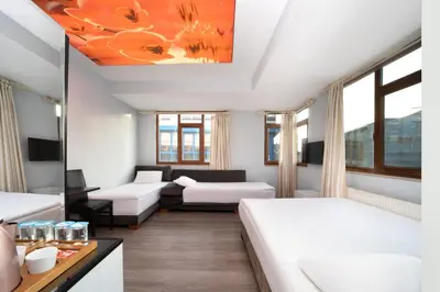 a living room with two beds and a couch at Park Çağlayan Hotel in Istanbul