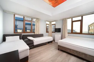 a room with two beds and a couch at Park Çağlayan Hotel in Istanbul