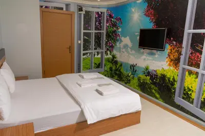 a room with a bed and a tv on a wall at Heraldic Room Hotel in Esenyurt