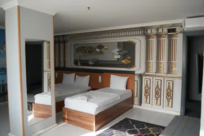 a bedroom with two beds and a mirror at Heraldic Room Hotel in Esenyurt