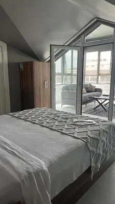 a large bed in a room with a large window at Heraldic Room Hotel in Esenyurt