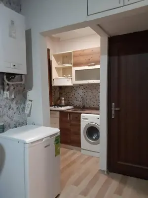 a kitchen with a washing machine and a washer at Easeinn in Istanbul