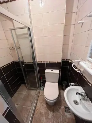 a bathroom with a toilet and a shower and a sink at Easeinn in Istanbul