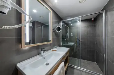 a bathroom with a sink and a shower at Csk The Halich Port İstanbul in Istanbul