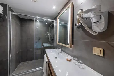 a bathroom with a shower and a white sink and a shower at Csk The Halich Port İstanbul in Istanbul