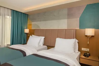 a hotel room with two beds and a painting on the wall at Csk The Halich Port İstanbul in Istanbul