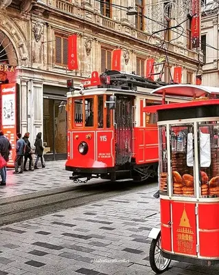 a red trolley car driving down a city street at Rodin Hostel in Istanbul