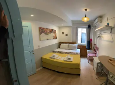 a bedroom with a bed and a room with a desk at Rodin Hostel in Istanbul