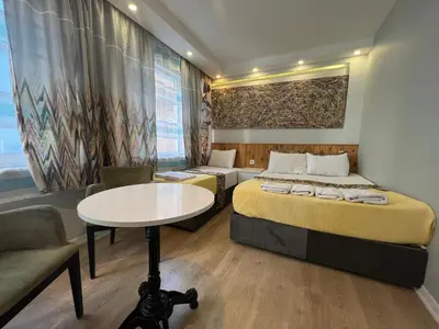 a bedroom with a bed and a table and a couch at Rodin Hostel in Istanbul