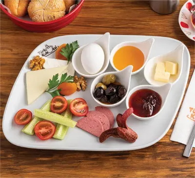 a plate with different types of food on a table at Intercity Hotel Istanbul Airport in Arnavutköy