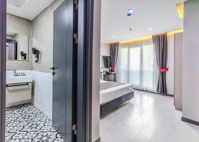 a bathroom with a tub and a bed in a room at Intercity Hotel Istanbul Airport in Arnavutköy