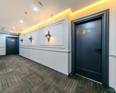 an office hallway with a door and a carpet at Intercity Hotel Istanbul Airport in Arnavutköy