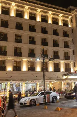 a white car parked in front of a building at The Center Hotel in Istanbul