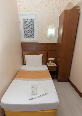 a small room with two beds and a window at The Center Hotel in Istanbul