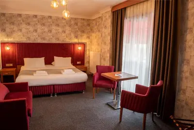 a hotel room with a bed and a table and chairs at My Palace Residance in İçmeler