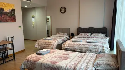 a room with three beds in a room at Nur Sena's House in Istanbul