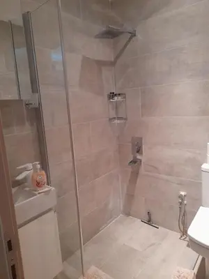 a shower stall with a glass door in a bathroom at Turkish Mountain Retreat in Saadet