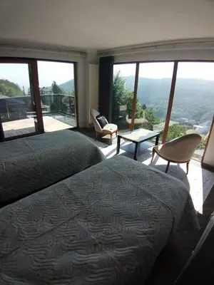 a bedroom with a bed and a balcony with a view at Turkish Mountain Retreat in Saadet