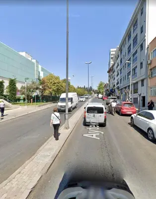 a person walking down a busy city street with cars at İstanbul'un merkezinde Cevahir AVM karşısı 1+1 yeni ev in Istanbul