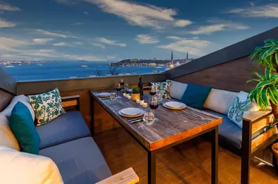 a table on a balcony with a view of the ocean at Monnas Bosphorus in Istanbul