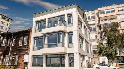 a tall white building with windows on a city street at Monnas Bosphorus in Istanbul