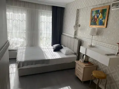 a small bedroom with a bed and a window at antik sofia hotel in Istanbul