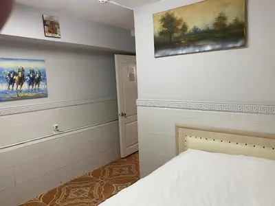 a bedroom with a bed and two paintings on the wall at antik sofia hotel in Istanbul