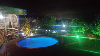 a night view of a swimming pool with lights at Sapanca Green Dome in Sapanca
