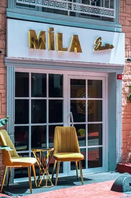 two chairs and a table in front of a store at MİLA SUİTES TAKSİM in Istanbul