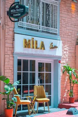 a restaurant with two chairs in front of a mall at MİLA SUİTES TAKSİM in Istanbul