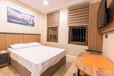 a small bedroom with a bed and a table at Valens Boutique Hotel in Istanbul