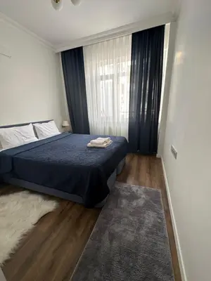 a bedroom with a bed and a large window at Center of city in Beşiktaş 2 plus 1 with 2 Bathroom and 3 Air Conditioner in Istanbul