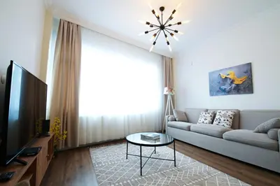 a living room with a couch and a television at Center of city in Beşiktaş 2 plus 1 with 2 Bathroom and 3 Air Conditioner in Istanbul