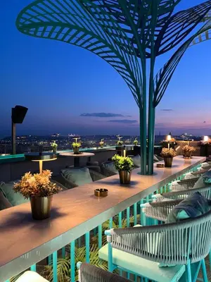 a balcony with tables and chairs and a view of the city at Ayramin Exclusive Hotel - Special Category in Istanbul
