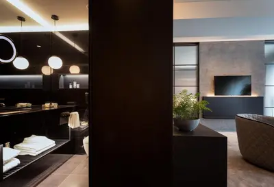 a dining room with black walls and a potted plant at The Mill Bomonti in Istanbul