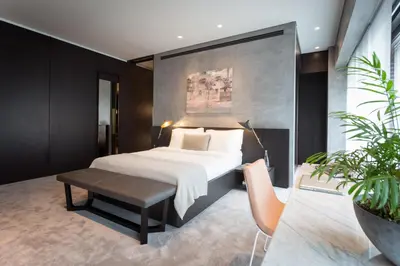 a bedroom with a bed and a table and a couch at The Mill Bomonti in Istanbul