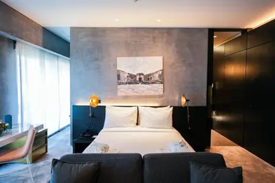 a bedroom with a bed and a couch at The Mill Bomonti in Istanbul